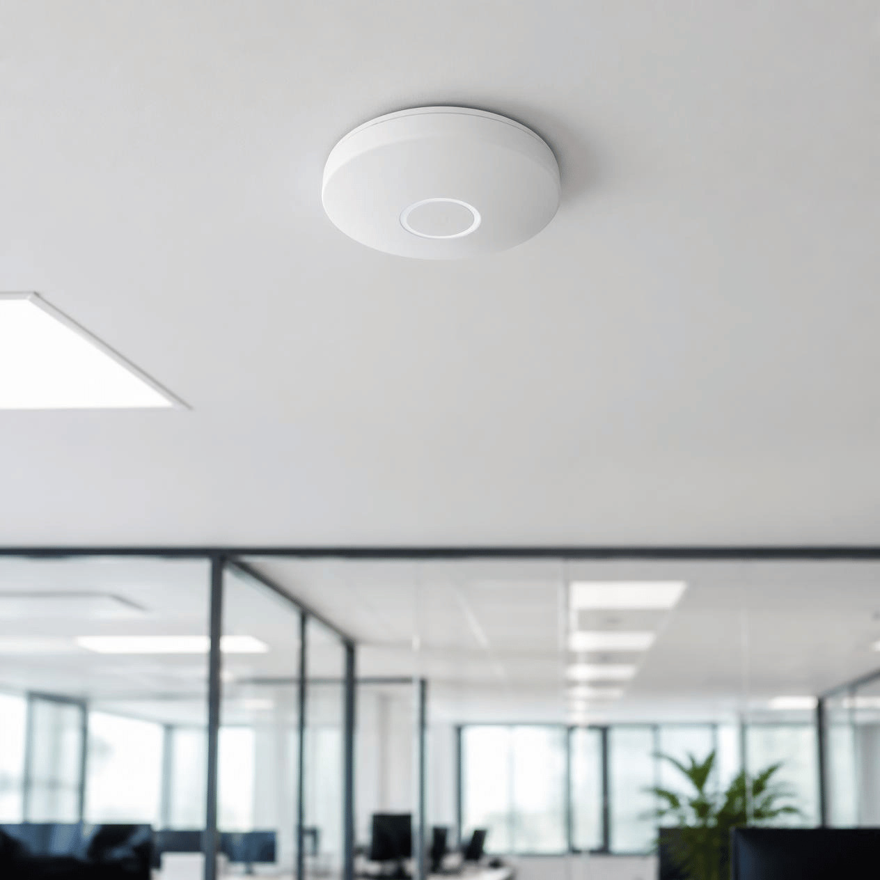 Ceiling-mounted wireless access point in a modern office ceiling